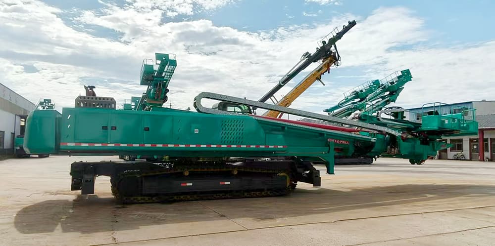 Crawler slope drill with mast raised for mid-height work