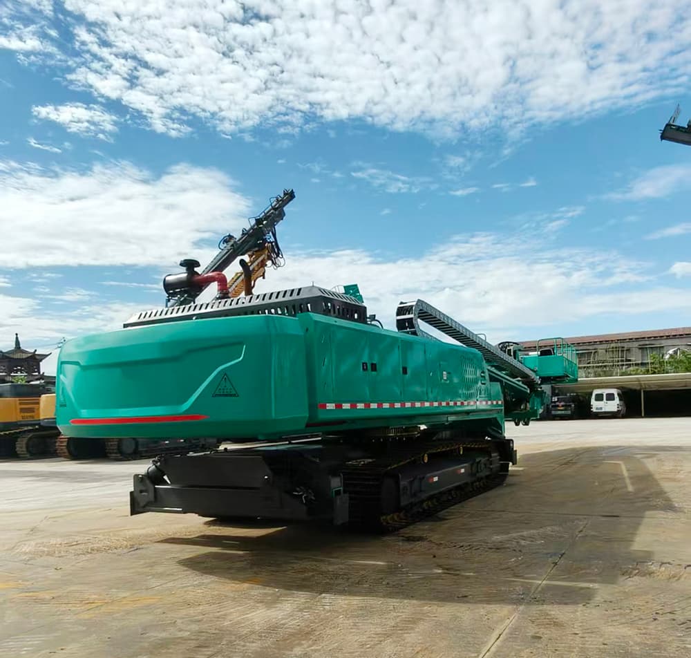 Teal crawler slope drilling rig photographed in a supplier yard